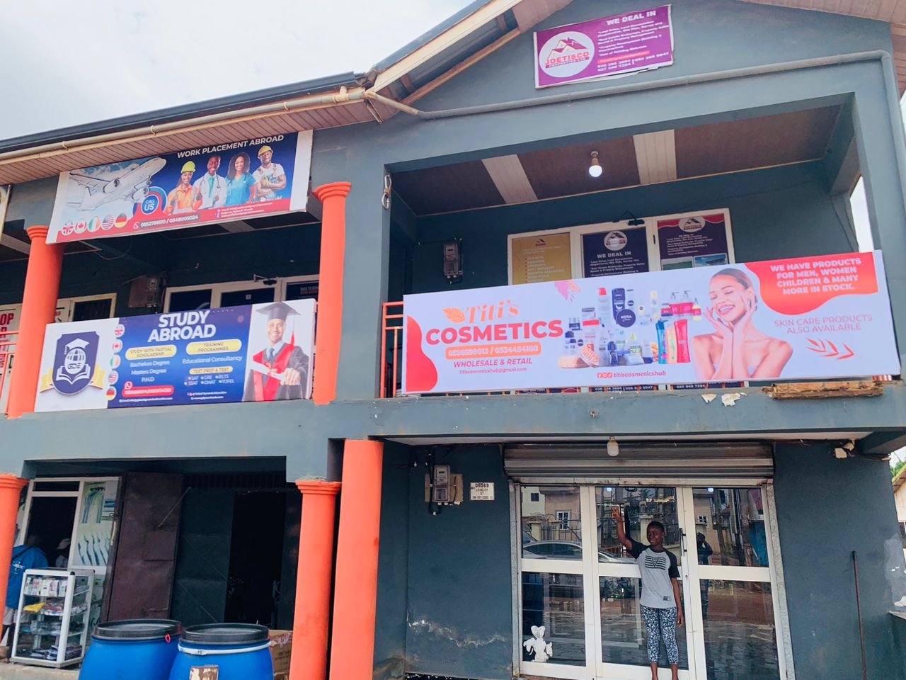 Titi's Cosmetics and Joetisco storefront signage